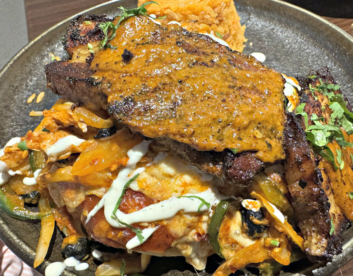 A sort of layered Mexican casserole, cazuela nortena is one of the more unusual dishes on the menu and includes a long list of ingredients, including the crispy pork belly on top.<br />(Sarah Baker Hansen / Flatwater Free Press)