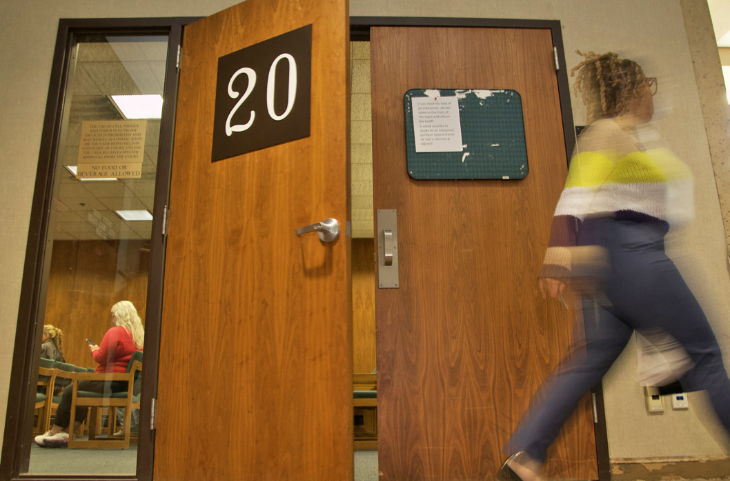 Avery Brown, an attorney with the Tenant Assistance Project, walks out of Courtroom 20 at the Douglas County court on Tuesday, Nov. 7. Courtroom 20 hosts eviction proceedings four days a week.<br />(Jeremy Turley / Flatwater Free Press)