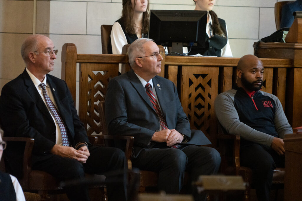 Nebraska State Sens. Myron Dorn, Robert Clements and Terrell McKinney (left to right) listen to Gov. Jim Pillen during his first State of the State on Wednesday, Jan. 25, 2023, in Lincoln, Neb. (Zach Wendling / Nebraska Examiner)