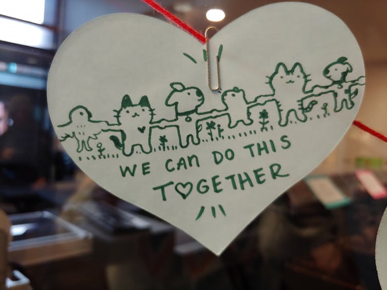 After the fire, residents sought ways to express support for their friends and neighbors. A small table with paper hearts was set up at the Louisville Public Library, where people were encouraged to leave a note of support or reflection. The hearts were displayed on the windows at the library.<br />(Courtesy of the Louisville Historical Museum)