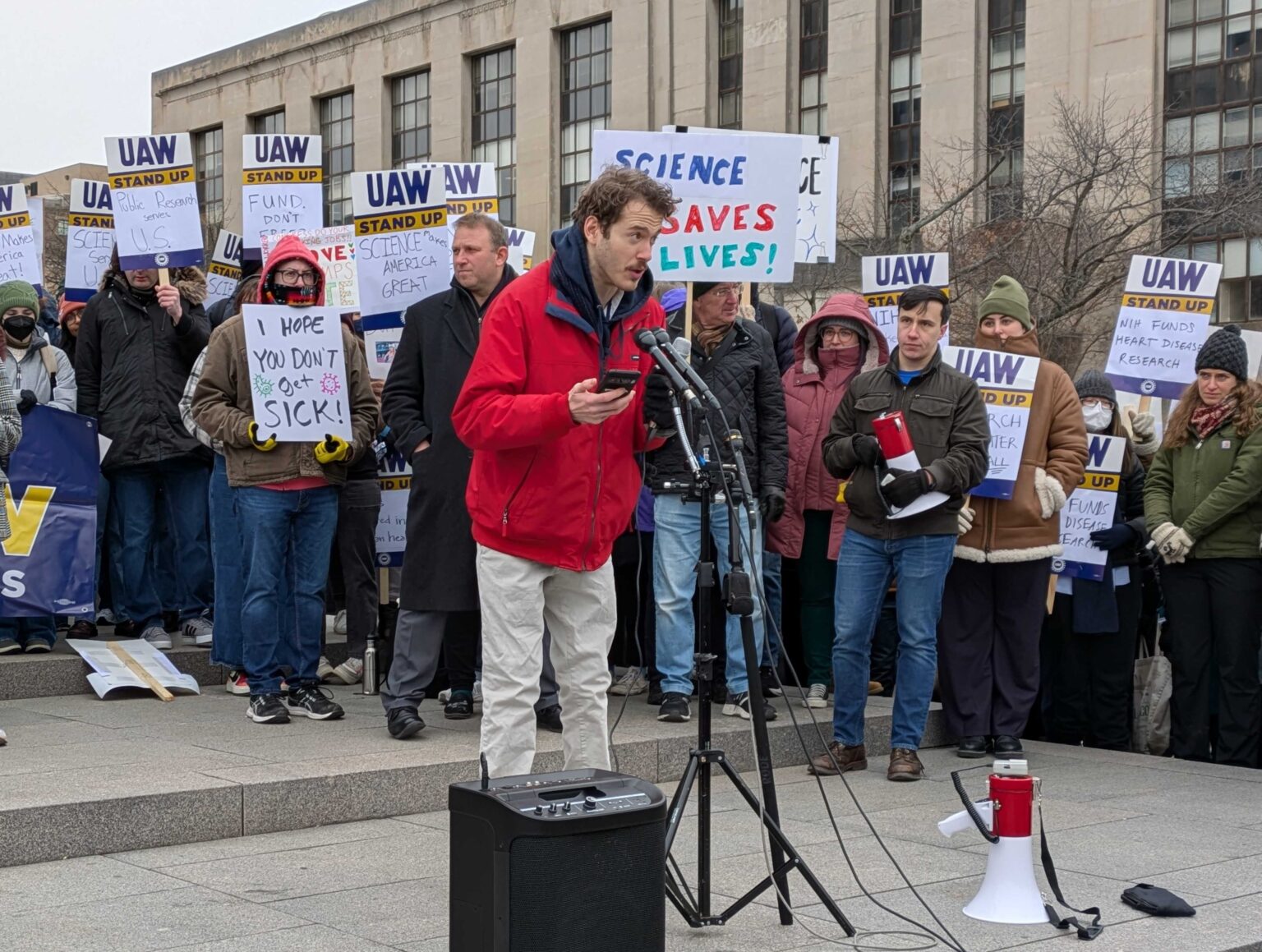 Connor Phillips, 25, told a crowd at a rally for federal workers that he’s losing his unpaid research training position at the National Institutes of Health, where he studies therapies for children with cerebral palsy. Phillips, who has benefited from cerebral palsy treatment, attended the rally outside the U.S. Department of Health and Human Services in Washington, D.C., on Feb. 19, 2025.<br />(Ashley Murray / States Newsroom)