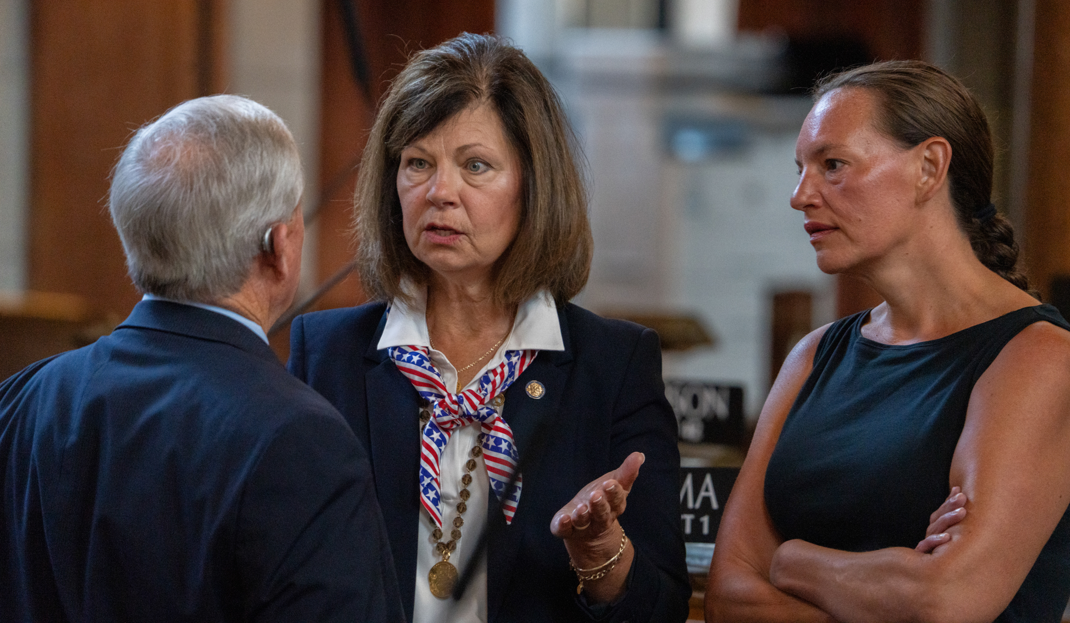 State Sen. Teresa Ibach of Sumner (center) talks with State Sen. Steve Erdman of Bayard and State Sen. Danielle Conrad of Lincoln.<br />(Zach Wendling / Nebraska Examiner)