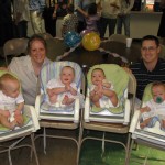 The Woollen quads' Feb. 9, 2009, baptism at Kearney's Faith United Methodist Church was followed by a first birthday party with family, friends and four cakes. (From left) are Brett, Parker, Kaden and Cooper, with their parents Rachel and Lee. (Lori Potter / Flatwater Free Press)