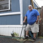 Todd Alexander poses at his mobile home in Milton, Vt., that he heats with the help of the Low Income Heating Home Energy Assistance Program. Alexander, who is disabled and living on disability, said the assistance has helped him meet his energy needs and still have money left over to live. 
 (Wilson Ring / AP Photo)