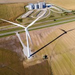 A farmer harvests a crop of soybeans using a combine just beneath a wind turbine, just west of Fairmont, Neb., on Tuesday, Sept. 26, 2023. 
(Kenneth Ferriera / Lincoln Journal Star via AP)