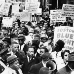 Dr. Martin Luther King Jr., is completely surrounded as he leads a civil rights march in Boston, April 23, 1965, en route to historic Boston Common where he will address a crowd.
 (AP Photo)
