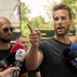 Andrew Tate (left) watches his brother Tristan speak, outside a police station in Voluntari, Romania, Wednesday, May 21, 2025.
 (Vadim Ghirda / AP Photo)