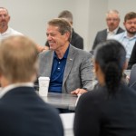 Nebraska Gov. Jim Pillen (center) addresses the new School Financing Review Commission during its first meeting on Aug. 12, 2025. 
(Zach Wendling / Nebraska Examiner)