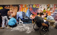 This inclusive community mural project celebrated the 20th anniversary of the Americans with Disabilities Act by creating a mural that integrated the artworks submitted by 13 Ohio artists with disabilities. Prof. Kong Ho (left) was the leading artist and worked with the participating Ohio artists during a 3-day intensive mural painting workshop in producing this 6-foot by 30-foot wide mural.
(Shari Lewis / The Columbus Dispatch via AP)