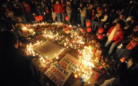 Millard South High School students hold a candle light vigil in front of the school in Omaha, Neb after a mass shooting on Thursday Jan 6, 2011. Ryan Busse once worked for a major gun-maker. He now warns about the danger of growing radicalization in the industry.  (Dave Weaver / AP Photo)