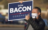 Nebraska 2nd Dist. Rep. Don Bacon, R-Neb., gives a thumbs-up sign as he campaigns at an intersection in Papillion, Neb., Tuesday, Nov. 3, 2020. 
(Nati Harnik / AP Photo)