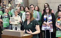 Sen. Machaela Cavanaugh, in the Nebraska state Capitol rotunda, during a rally to oppose the bill that would ban abortion once cardiac activity can be detected in an embryo, which is generally around the sixth week of pregnancy. (Margery A. Beck / AP Photo)