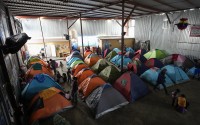 Asylum seekers wait for appointments through the CBP One app to apply for asylum in the United States in a shelter for migrants, Saturday, Feb. 3, 2024, in Tijuana, Mexico. 
(Gregory Bull / AP Photo)