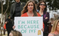 Sarah Brown, from Birmingham, Ala., holds a sign in support of IVF treatments during a rally advocating for IVF rights outside the Alabama State House on Wednesday, Feb. 28, 2024 in Montgomery, Ala. Brown has two children, age three and one, who were conceived using IVF at Birmingham Fertility center. 
(Stew Milne / AP Images for RESOLVE: The National Infertility Association)