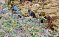 Pakistani laborers, mostly women, sort through empty bottles at a plastic recycling factory in Hyderabad, Pakistan, April 30, 2023. 
(Pervez Masih / AP Photo)