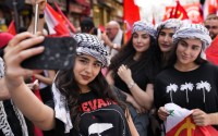 Supporters of the Lebanese Communist party take a selfie, as they march during a demonstration to mark International Labor Day or May Day, in Beirut, Wednesday, May 1, 2024. Despite the tense situation and ongoing clashes on Lebanon’s border with Israel over the past seven months, hundreds of protesters marched through Beirut’s streets to mark International Workers’ Day. 
(Hussein Malla / AP Photo)