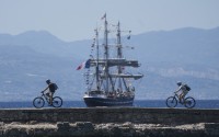 Cyclists pass in front of the Belem, the three-masted sailing ship carrying the Olympic flame to France, as it sails near Corinth, Greece, April 28, 2024. 
(Petros Giannakouris / AP Photo)