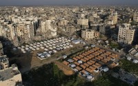 An aerial photograph taken by a drone shows a tent camp for displaced Palestinians amidst the destruction caused by the Israeli air and ground offensive in Beit Lahiya, northern Gaza Strip, on Monday, Feb. 17, 2025. 
(Mohammad Abu Samra / AP Photo)