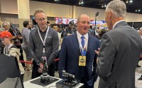 Berkshire Hathaway Vice Chairman Greg Abel (center) checks out the flight simulators offered by one of Berkshires companies, Flight Safety as he toured the exhibit hall Friday, May 3, 2024, in Omaha, Neb. ahead of Saturday's meeting. 
(Josh Funk / AP Photo)