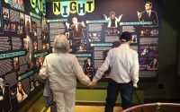 Mario and Gail Cirasunda, of Orchard Park, N.Y., look at exhibits from past and current comedy stars on display during a Memory Cafe event at the National Comedy Center Monday, May 5, 2025, in Jamestown, N.Y. 
(Jeffrey T. Barnes / AP Photo)