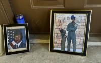 Candles and framed photos of Roger Fortson, a U.S. Air Force senior airman who was fatally shot by a Fla. sheriff's deputy on May 3, 2024, sit in the doorway of the apartment where he was killed in Fort Walton Beach, Fla., on Aug. 23. 
(Kate Payne / AP Photo)
