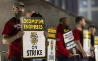 Union members from the Brotherhood of Locomotive Engineers and Trainmen form a picket line outside the NJ Transit Headquarters on Friday, May 16, 2025 in Newark, New Jersey. 
(Stefan Jeremiah / AP Photo)