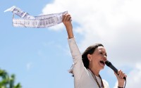 Opposition leader Maria Corina Machado holds up tally sheets during a protest against the reelection of President Nicolás Maduro one month after the disputed presidential vote which she says the opposition won by a landslide, in Caracas, Venezuela, Aug. 28, 2024. 
(Ariana Cubillos / AP Photo)