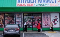 Women and children exit an Afghan grocery store in North Highlands, Calif., Friday, Dec. 5, 2025. 
(Godofredo A. Vásquez / AP Photo)