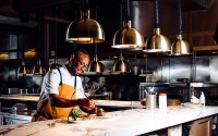 Pivot Prime head chef Joel Hassanali is pictured in Pivot Prime’s open concept kitchen at the restaurant, 13665 California St., which opened earlier this year. 
(Joshua Foo / Flatwater Free Press)