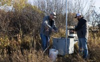 Water resources technicians Josh Schnitzler and Connor Baldwin, who both work for the Lower Elkhorn Resources District in Norfolk, prepare to test the water in a monitoring well near the north fork of the Elkhorn River in 2022. A recent state-led effort to test private wells in Nebraska found 15% had nitrate levels above what the Environmental Protection Agency considers safe. 
(Ryan Soderlin / Flatwater Free Press)