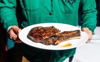 The bone-in ribeye at 801 Chophouse, served to you by a waiter in a crisp green jacket. 
(Joshua Foo / Flatwater Free Press)

