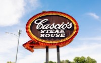 An old-school glowing sign marks the location of Cascio’s, in Omaha’s Little Italy neighborhood. 
(Joshua Foo / Flatwater Free Press)