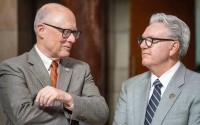 Speaker of the Nebraska Legislature John Arch (left) talks with former Speaker Jim Scheer of Norfolk. Scheer now serves on the University of Nebraska Board of Regents, June 6, 2025. 
(Zach Wendling / Nebraska Examiner)