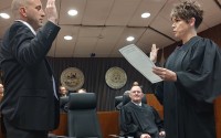 The Honorable Marcela A. Keim administers Philip Keenan Kleine's Oath of Office in a room full of smiling well-wishers Friday, May 2, 2025.
(Austin Petak / The Daily Record)
