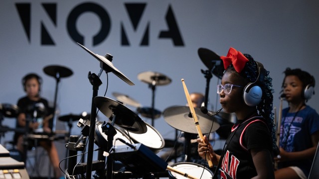 Ava Hardy, 7, learns to play drums during a summer camp at North Omaha Music & Arts in Omaha. 
(Rebecca S. Gratz / Flatwater Free Press)