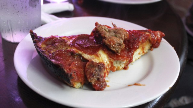 A slice of deep-dish pizza is shown at Pequod's in Chicago Sept. 5, 2014. Chicago is one of a handful of cities across the country, like Boston, Milwaukee and New York, with companies that offer tours of the local pizza scene.
 (Caryn Rousseau / AP Photo)