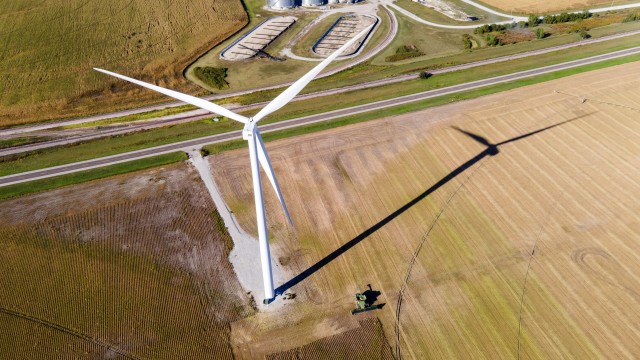 A farmer harvests a crop of soybeans using a combine just beneath a wind turbine, just west of Fairmont, Neb., on Tuesday, Sept. 26, 2023. 
(Kenneth Ferriera / Lincoln Journal Star via AP)