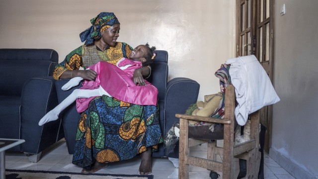 Fatoumata Sané holds her daughter Aissata, 8, who suffers from a rare genetic disease, at their home in Dakar, Senegal, Saturday, Jan. 11, 2025. 
(Annika Hammerschlag / AP Photo)