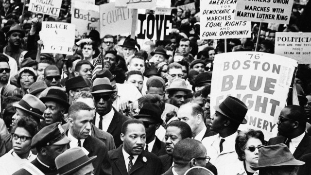 Dr. Martin Luther King Jr., is completely surrounded as he leads a civil rights march in Boston, April 23, 1965, en route to historic Boston Common where he will address a crowd.
 (AP Photo)