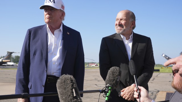 President Donald Trump (left) listens as Commerce Secretary Howard Lutnick speaks with reporters before boarding Air Force One at Morristown Municipal Airport in Morristown, N.J., Sunday, July 6, 2025, en route to Washington. 
(Jacquelyn Martin / AP Photo)