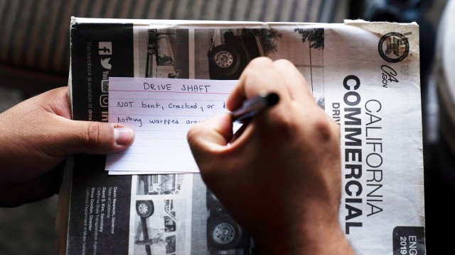 A student truck driver makes flash cards for his commercial driver's license exam while taking a class in Calif., Nov. 15, 2021.
(Jae C. Hong / AP Photo)