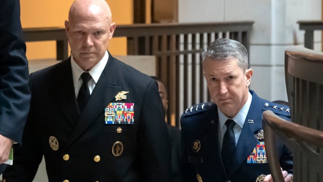 U.S. Navy Adm. Frank M. Bradley, accompanied by Gen. Dan Caine, chairman of the Joint Chiefs of Staff (right) walks to a meeting with senators on Capitol Hill, Thursday, Dec. 4, 2025, in Washington. 
(Mark Schiefelbein / AP Photo)