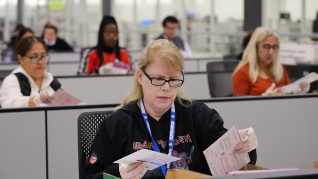A worker examines ballots at the L.A. County Ballot Processing Center Nov. 4, 2025, in City of Industry, Calif. 
(Ethan Swope / AP Photo)