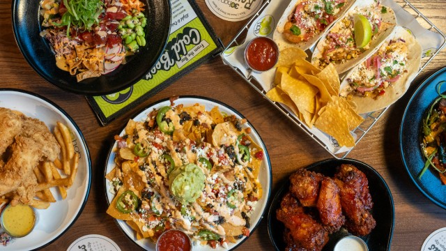 Dishes from the Omaha location of 30Hop include, from top left: an Ahi poke bowl, shrimp tacos, Buffalo wings, nachos and chicken strips.
 (Courtesy photo)