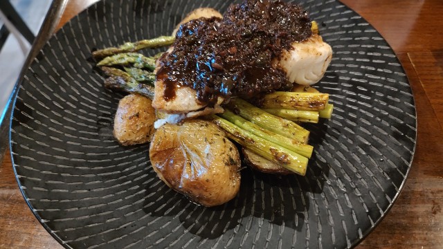The Wild Halibut fillet. The potatoes were so fresh, the fish so soft, and the tapenade made sound mockery of my senses. 
(Austin Petak / The Daily Record)