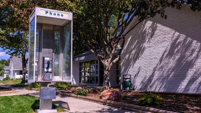 The pay phone outside the Pierce Telephone Co. in Pierce wasn’t working when someone tried to use it, so Jeff Kesting, the phone company’s plant manager, fixed the problem so the phone would work again. 
(Darin Epperly / Flatwater Free Press)