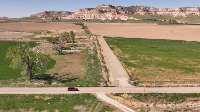 Rural letter carrier Roger McDonald prefers to drive a Dodge Caravan on his rural route, located in Scotts Bluff County, Neb. The area is known for its beautiful rugged bluffs and some native prairie grasses. 
(Nick Loomis / The Midwest Newsroom)