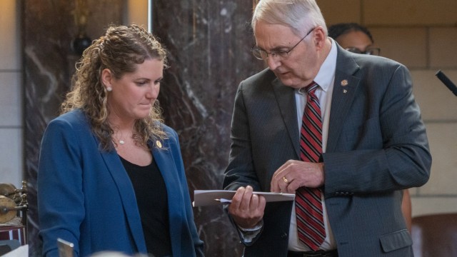 State Sen. Rob Clements of Elmwood (right)talks with State Sen. Carolyn Bosn of Lincoln on the floor of the Nebraska Legislature on Feb. 27, 2024. 
(Zach Wendling / Nebraska Examiner)