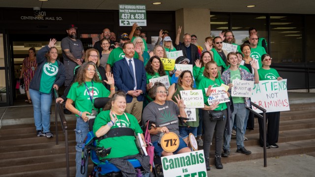 Advocates for medical cannabis join together before a public hearing at the Nebraska State Office Building in Lincoln, Nebraska, on state-drafted regulations for the new medicine approved by Nebraska voters in November 2024, Oct. 15, 2025. 
(Zach Wendling / Nebraska Examiner)