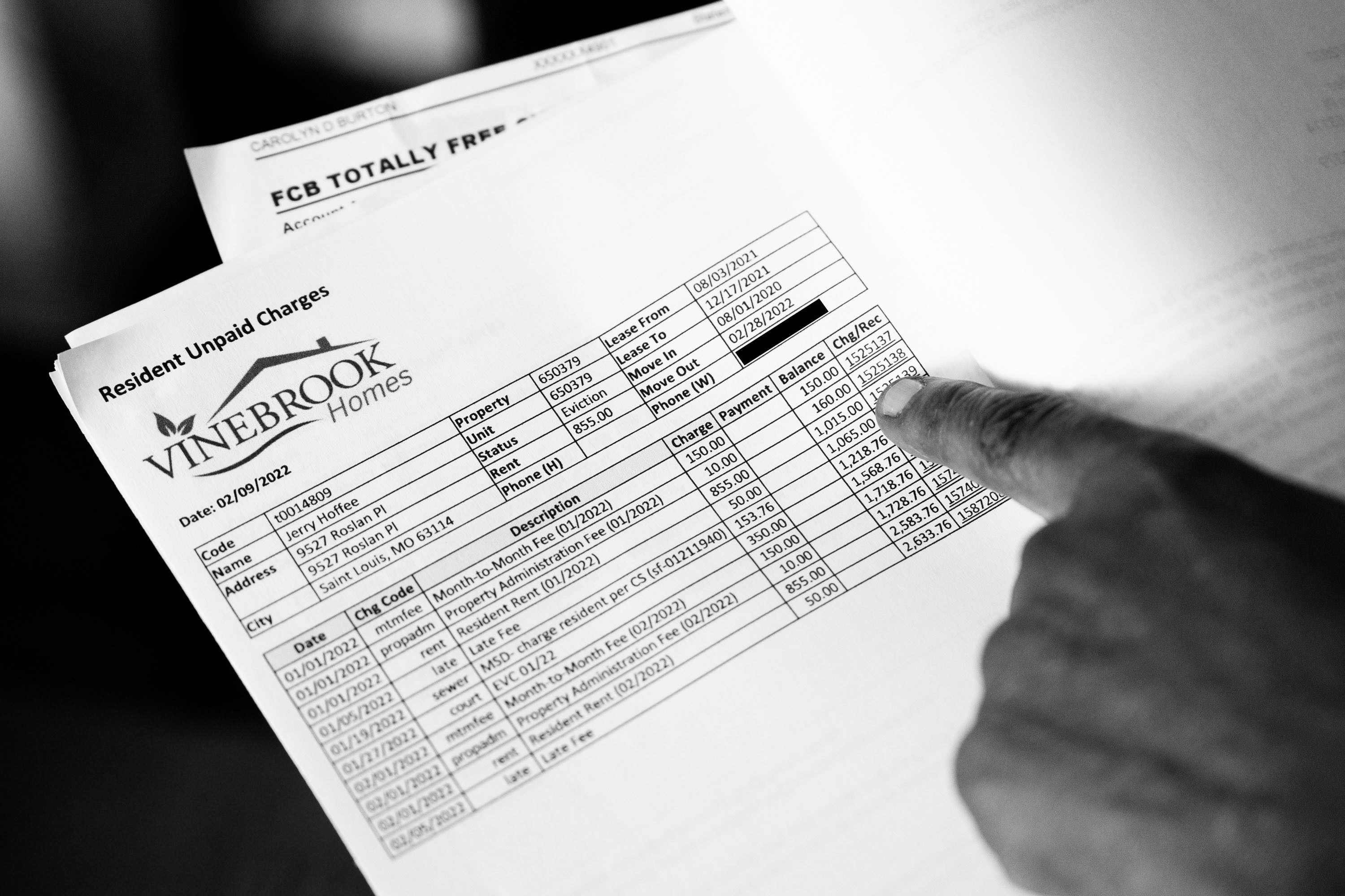 Carolyn Burton shows an invoice for ‘unpaid charges’.<br />(Brian Muñoz / St. Louis Public Radio)